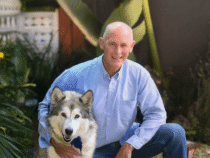Smiling man with husky in garden